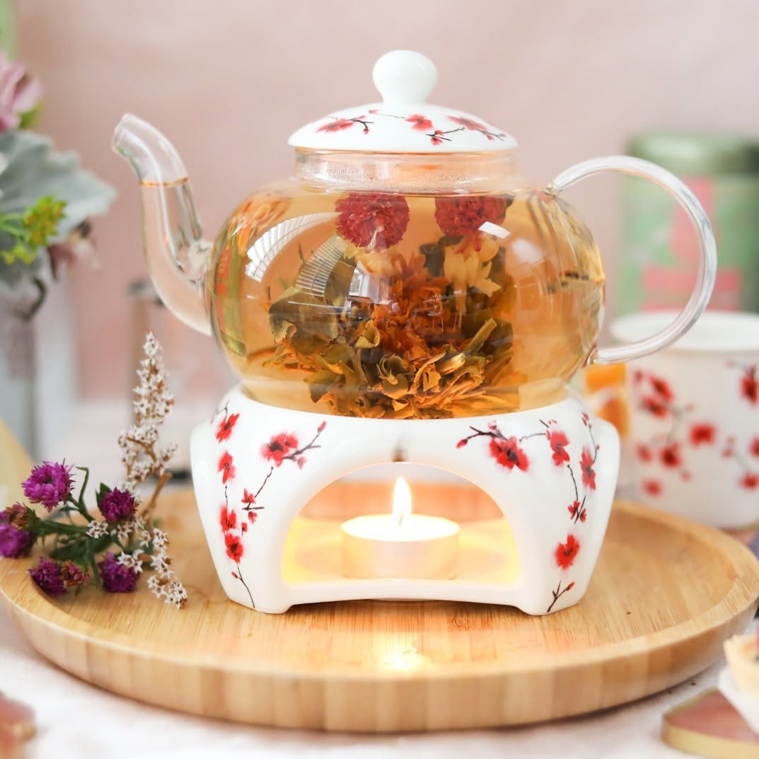 Teabloom flowering tea set unfurling in a clear glass pot